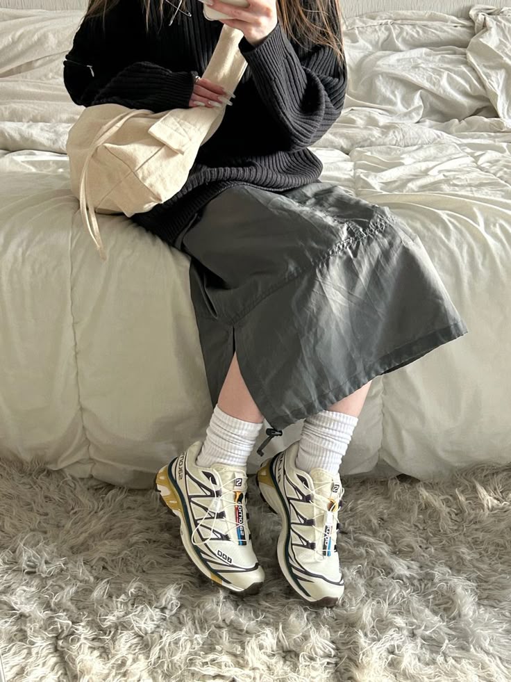 Neutral Salomon sneakers with a grey skirt