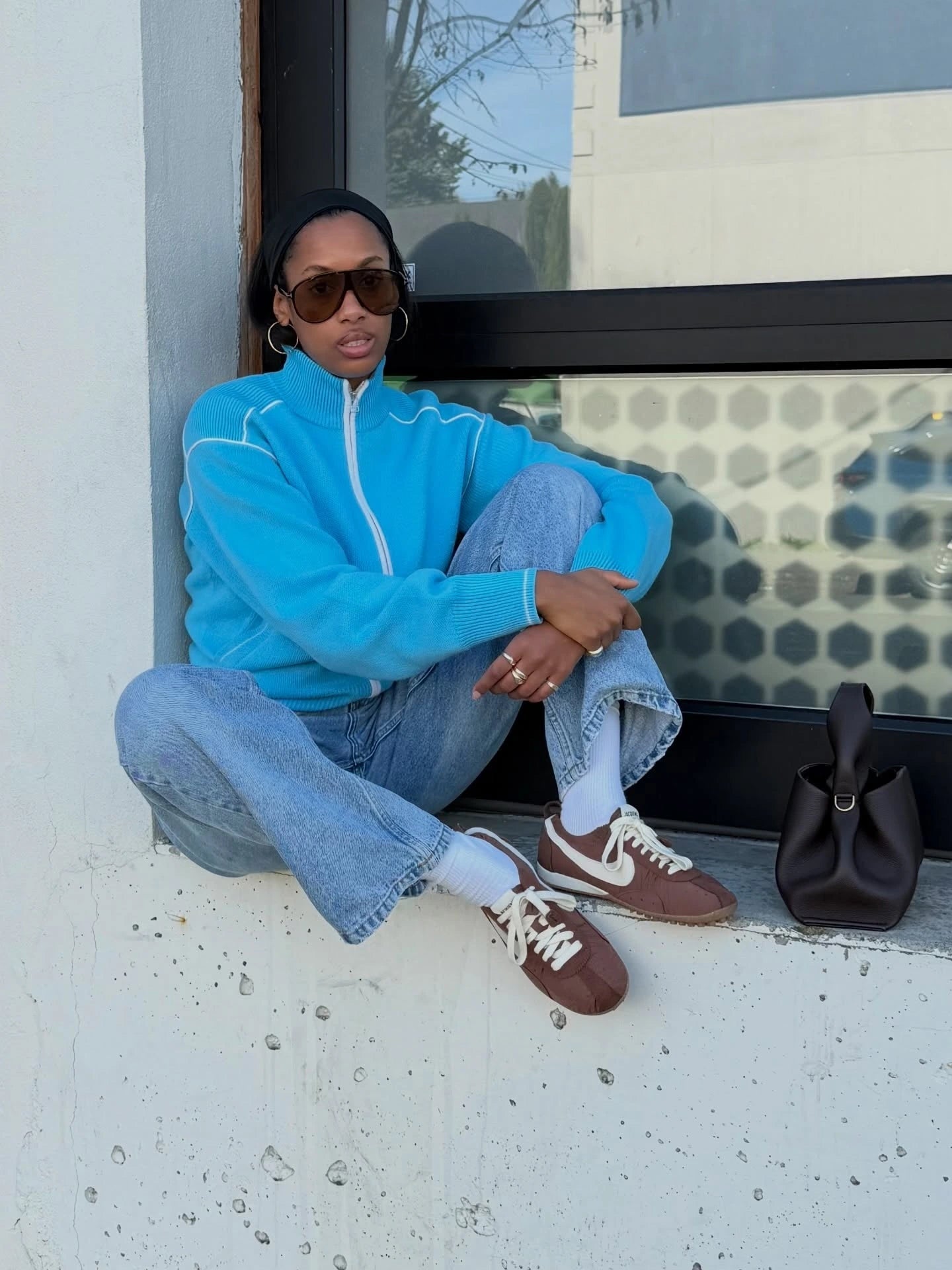 Brown sneakers styled with blue denim
